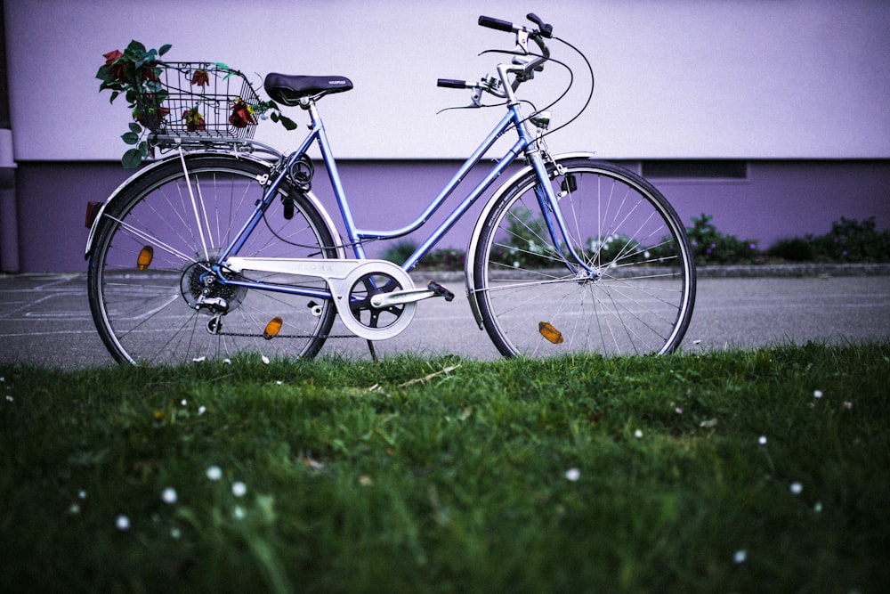 blue city bike on green grass field during daytime