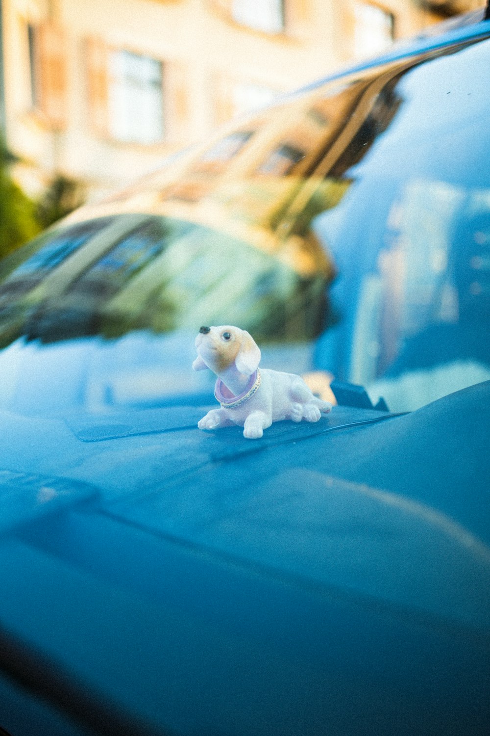 white and brown dog figurine