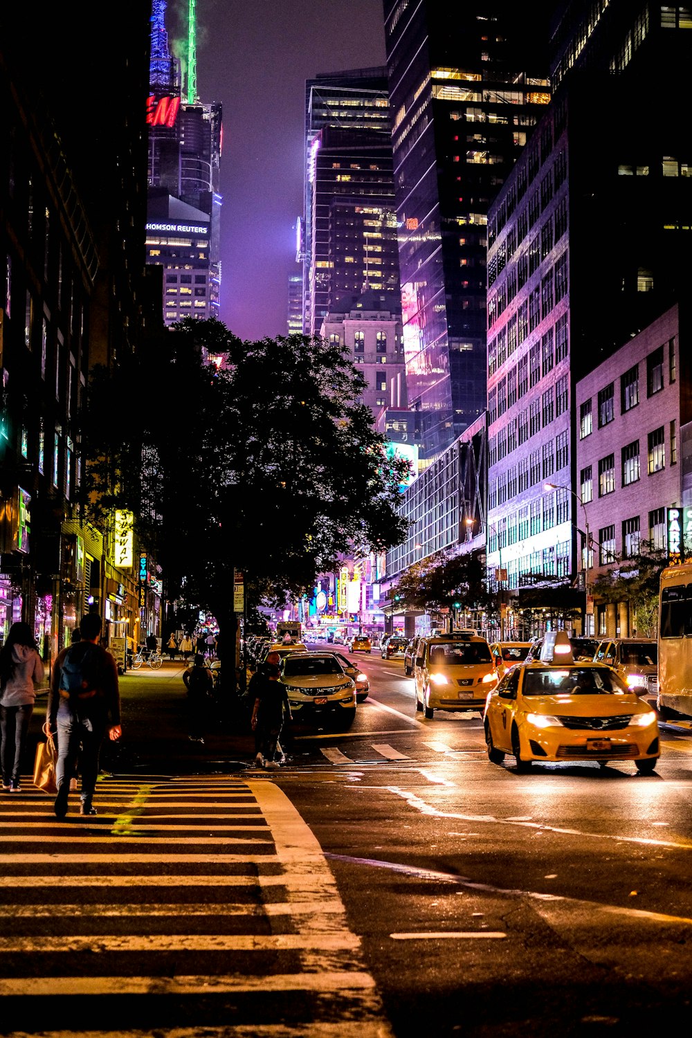 people walking on pedestrian lane during night time