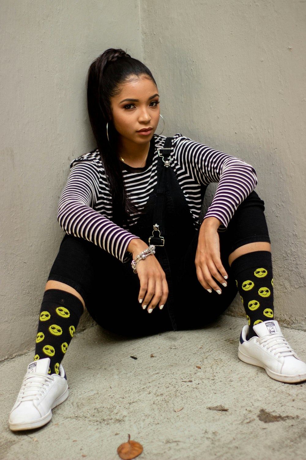 woman in black and white striped long sleeve shirt and black pants sitting on floor