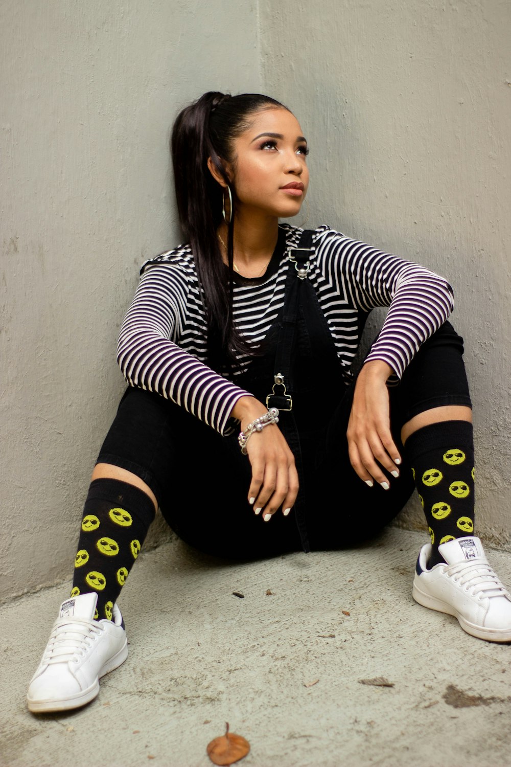 woman in black and white striped long sleeve shirt and black pants sitting on floor