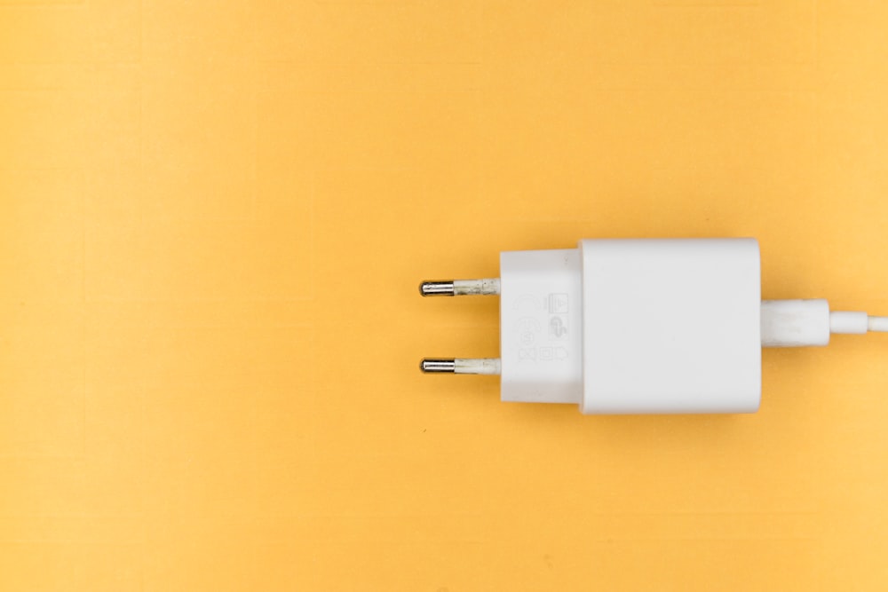 white adapter on yellow surface