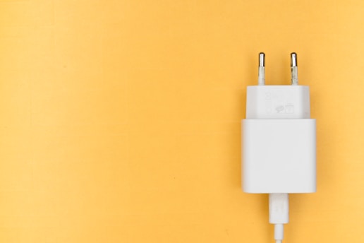 white adapter on yellow wall