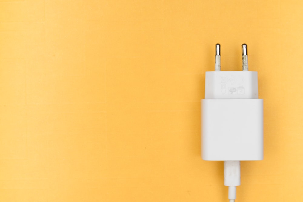 white adapter on yellow wall