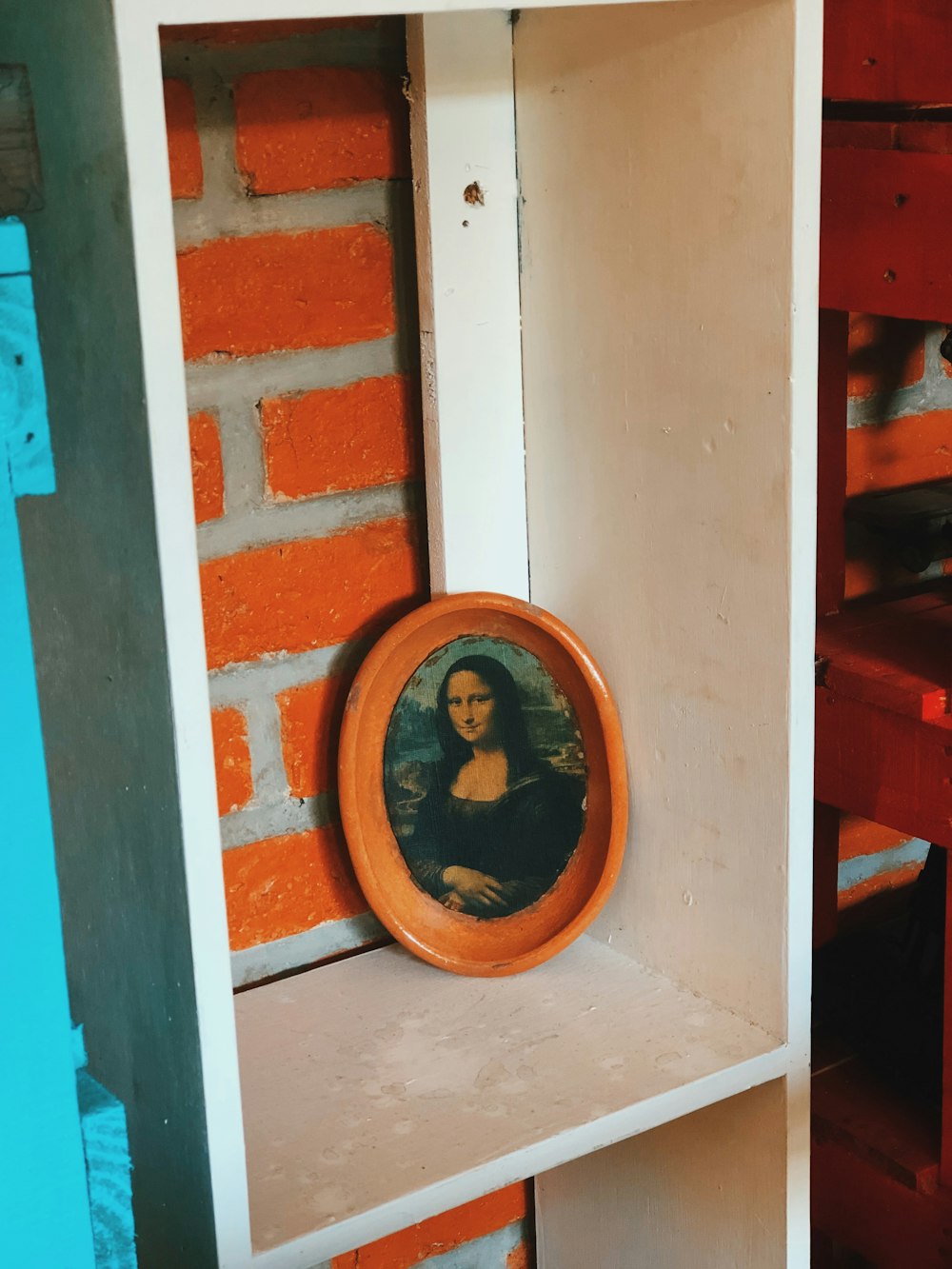 brown wooden round frame on brown wooden shelf