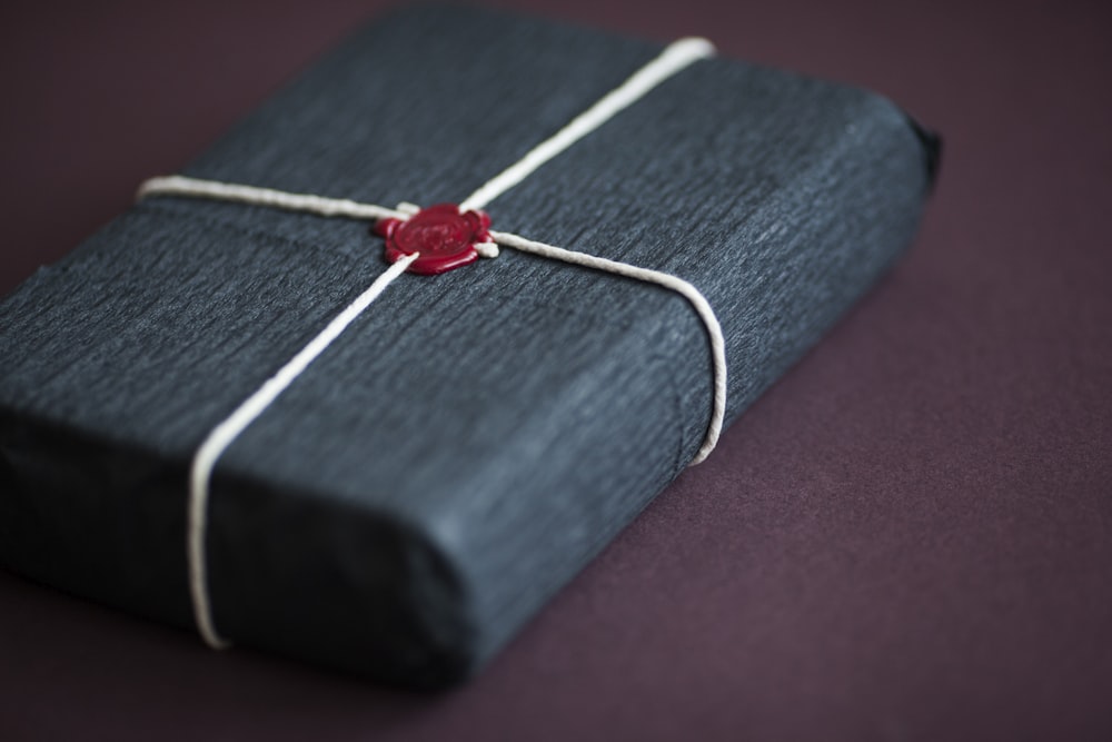 red and white cross pendant necklace on blue and white book