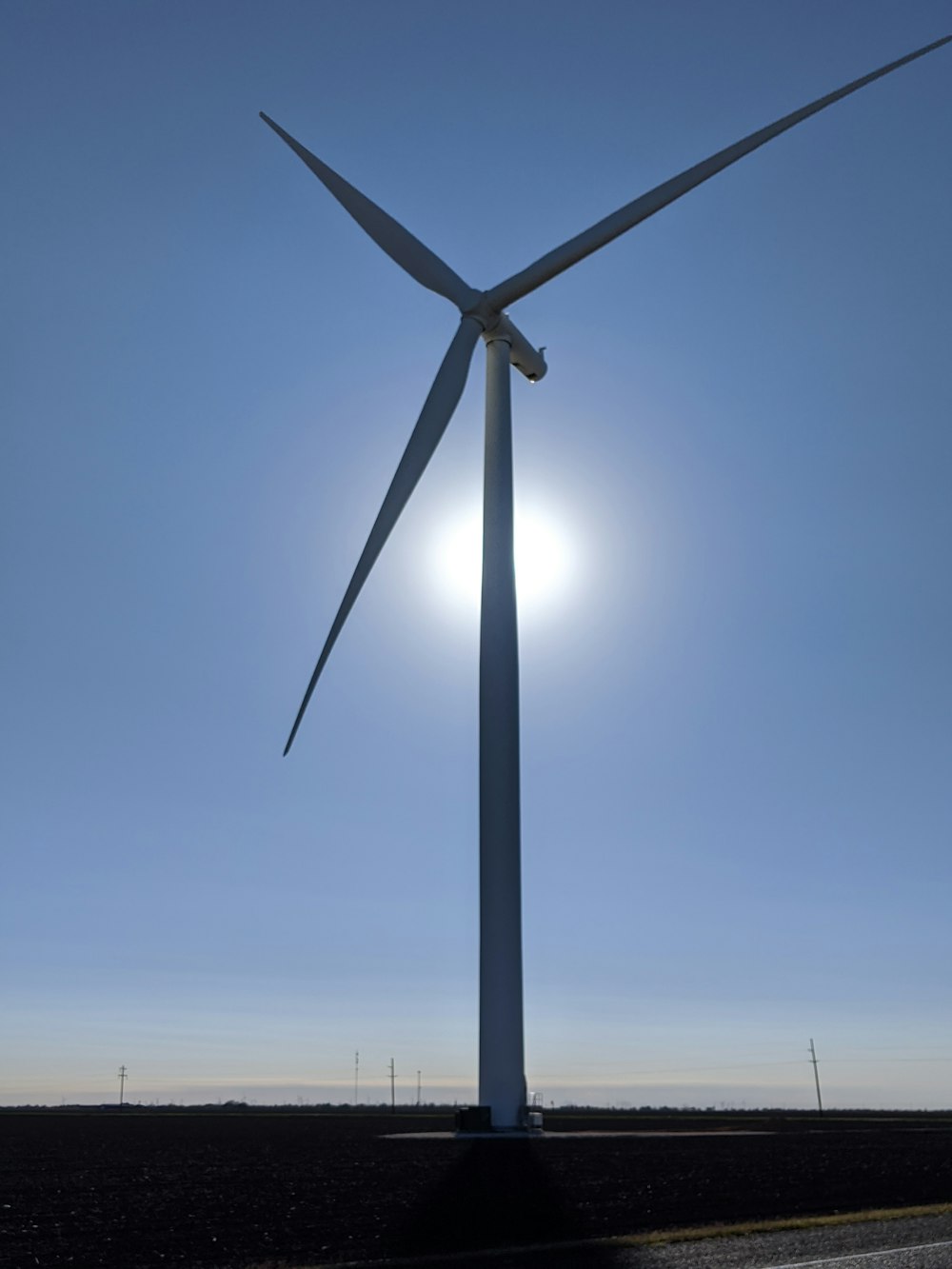 wind mill under blue sky during daytime