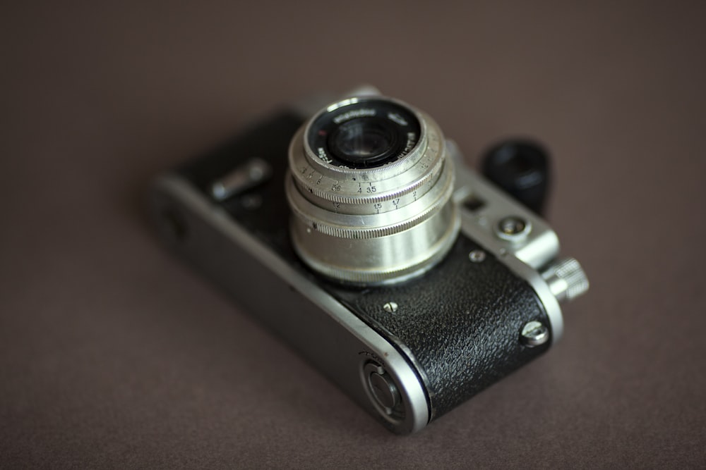 black and silver camera on red textile