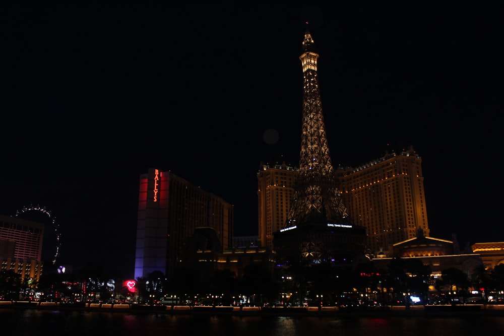 lighted tower near high rise building during night time