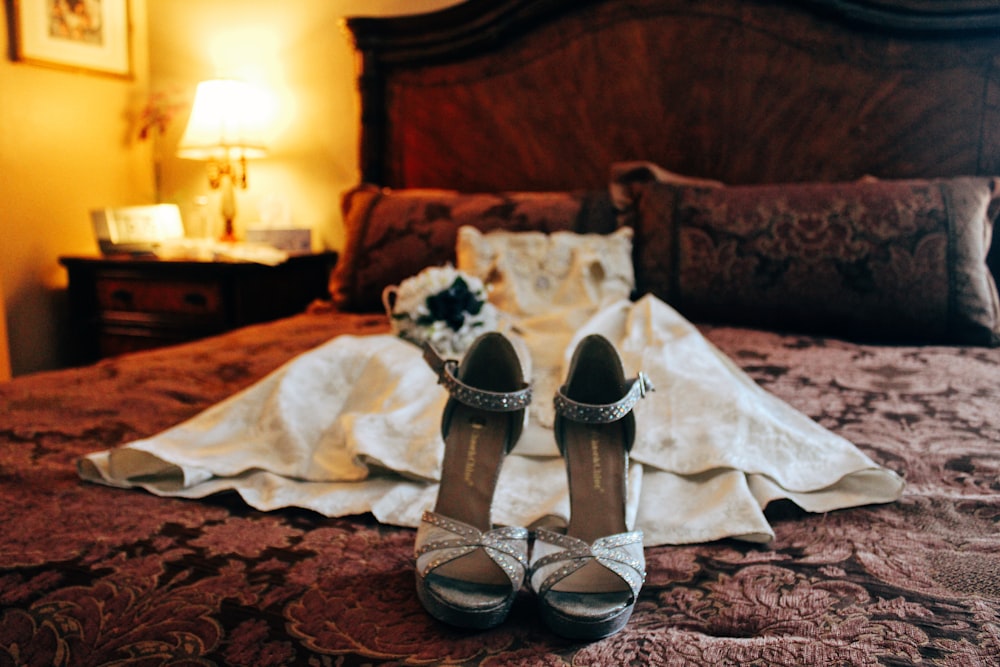 white and black open toe sandals on brown and black floral textile