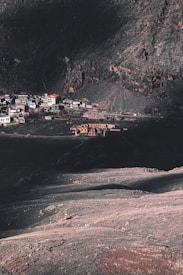 houses on hill near body of water during daytime