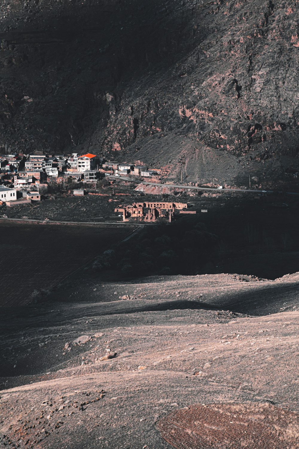 houses on hill near body of water during daytime