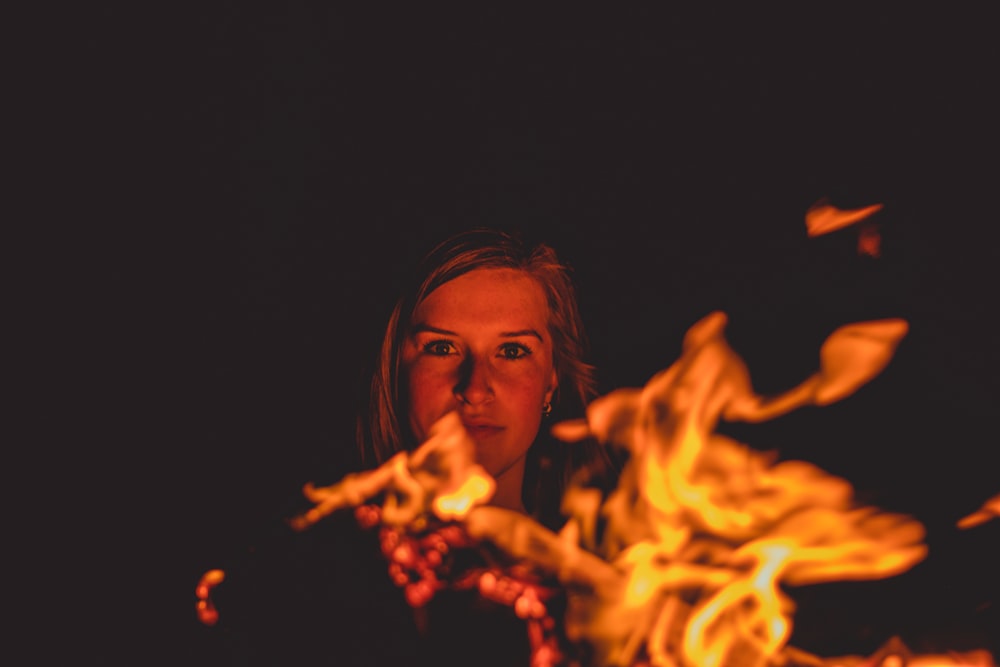 woman in black shirt holding fire