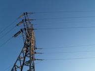 black electric post under gray sky