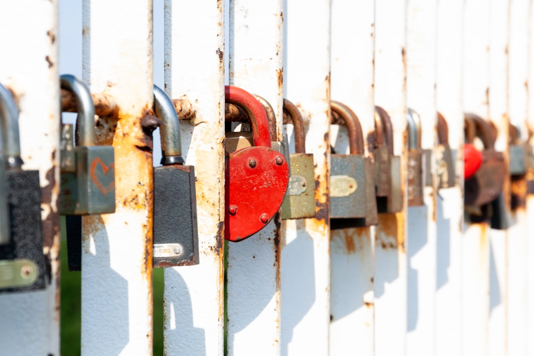 red padlock on white steel gate