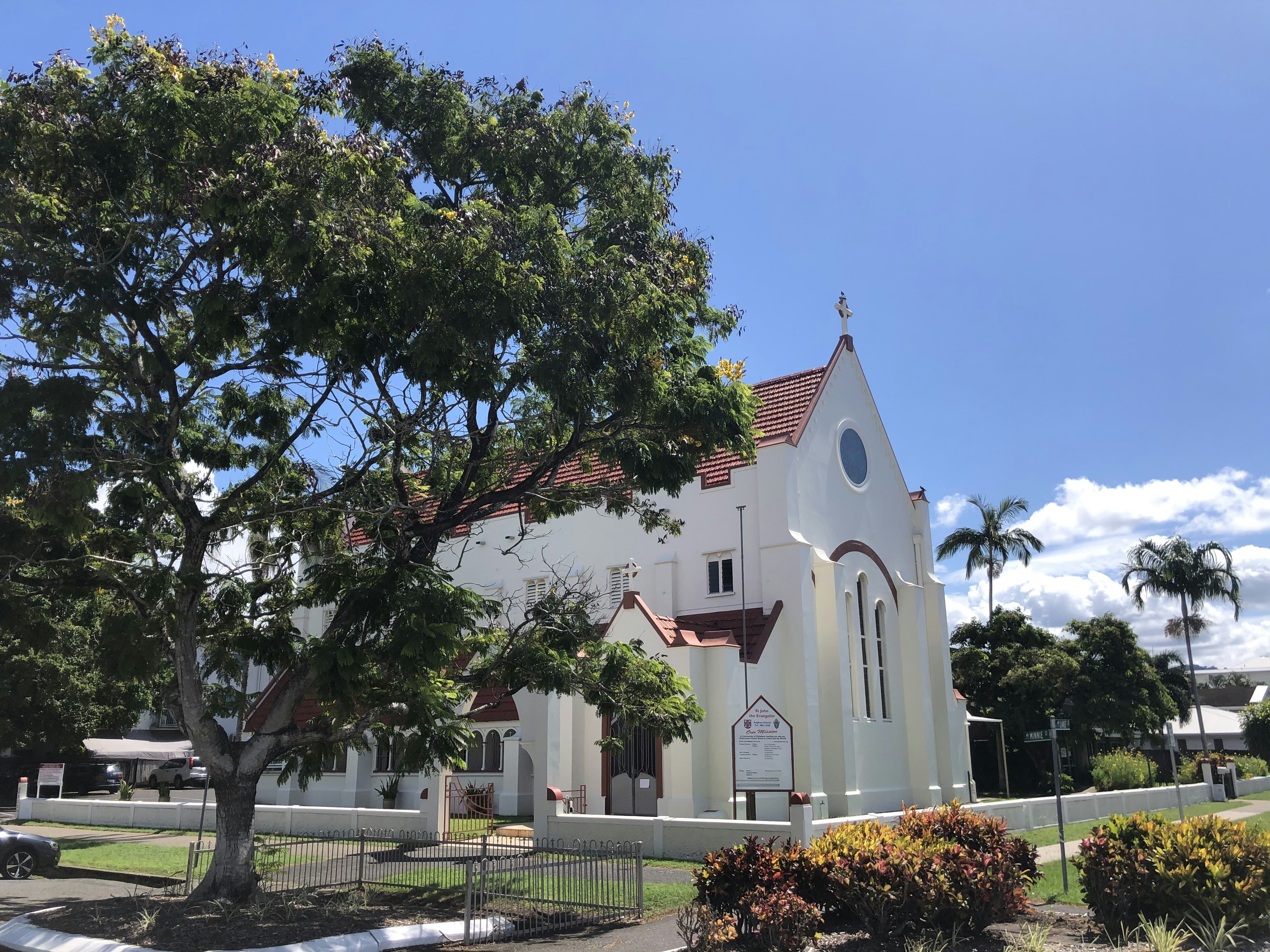 White church behind a large shade tree