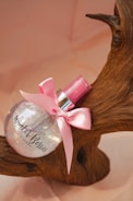 pink ribbon on brown wooden round table