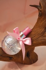 pink ribbon on brown wooden round table