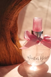 A lilac-toned body splash bottle with lavender sprigs and a misty fresh background.