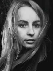 A minimalist portrait of a woman with flowing hair in soft pastel tones.