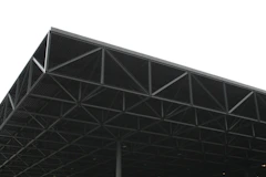 a large metal structure sitting under a white sky