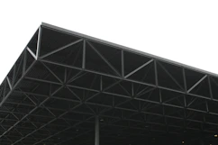 a large metal structure sitting under a white sky