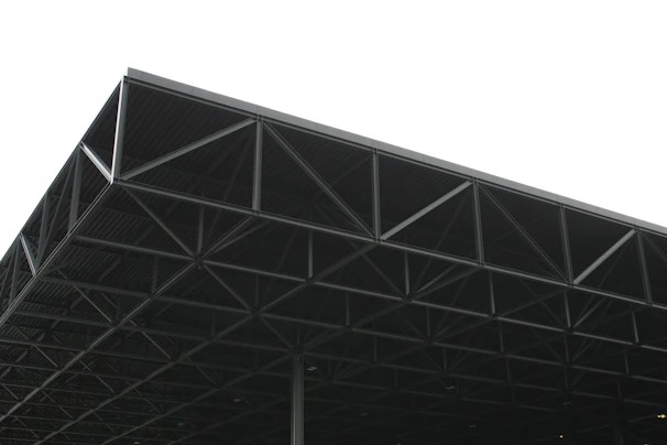 a large metal structure sitting under a white sky
