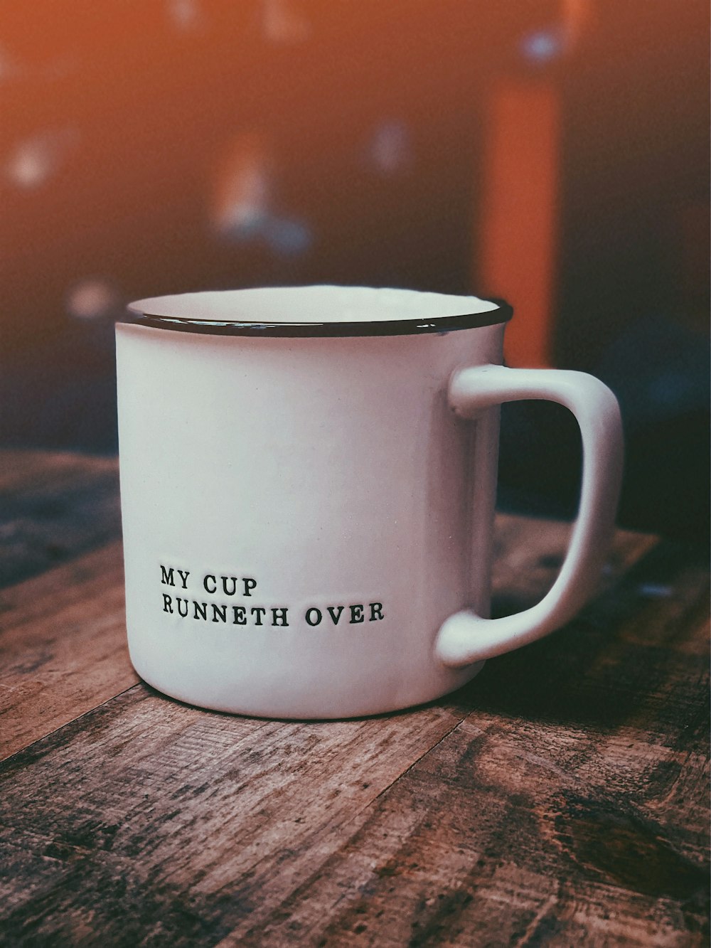 white ceramic mug on brown wooden table