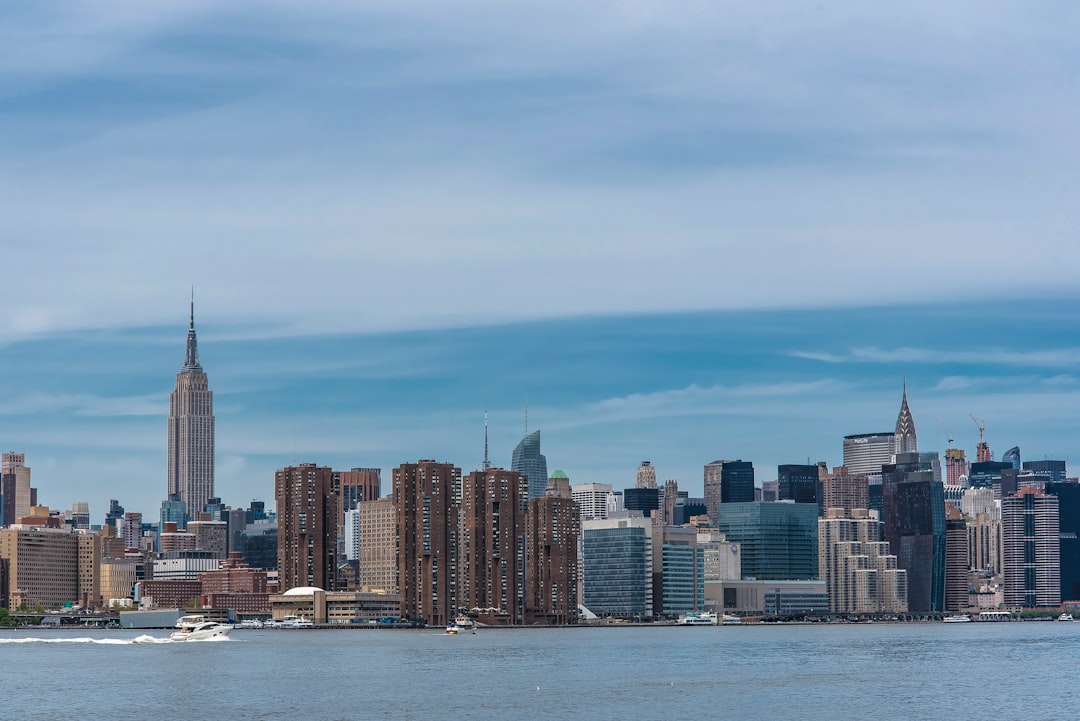 city skyline across body of water during daytime