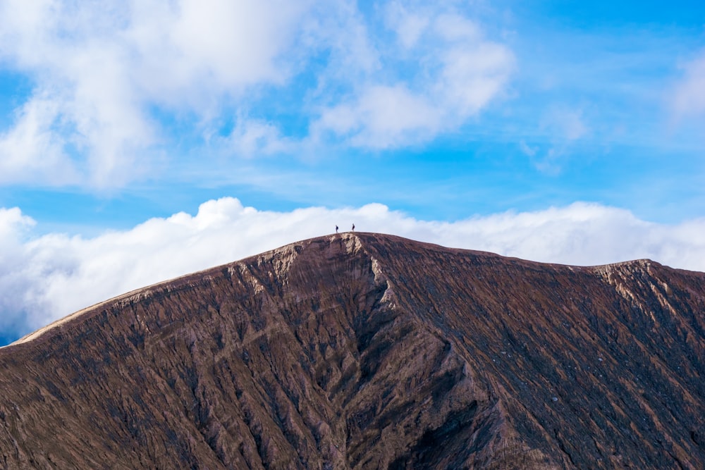 brown rocky mountain under blue sky during daytime