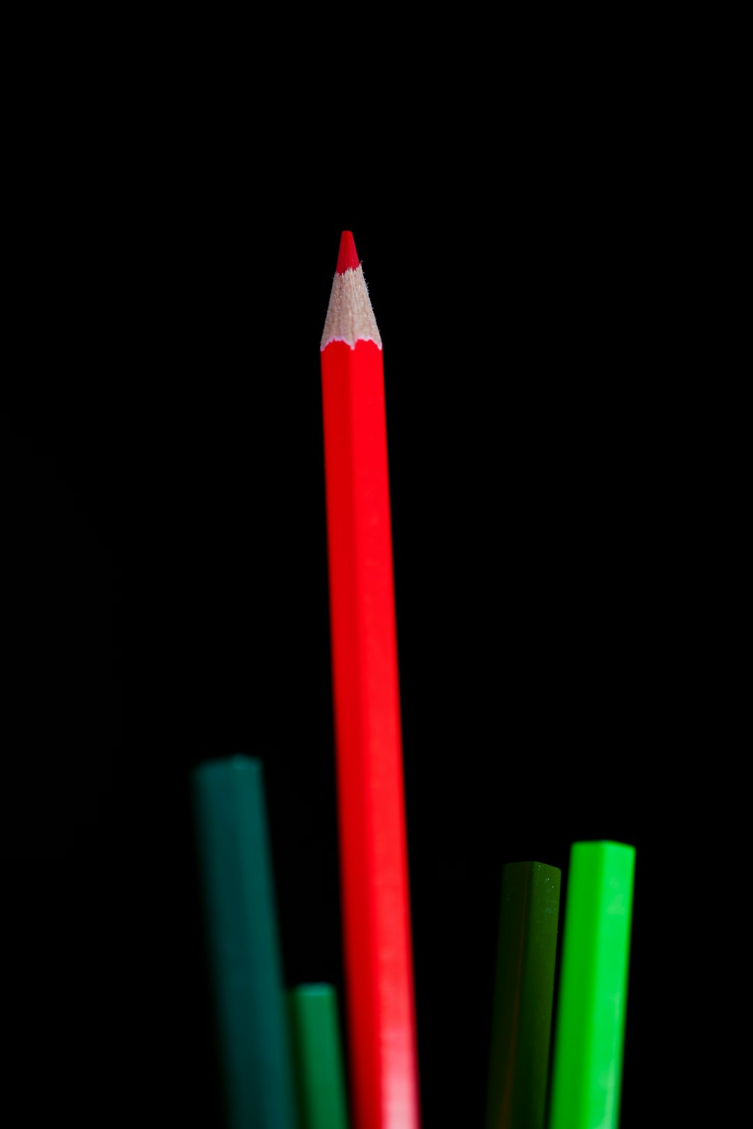 red color pencil on black background