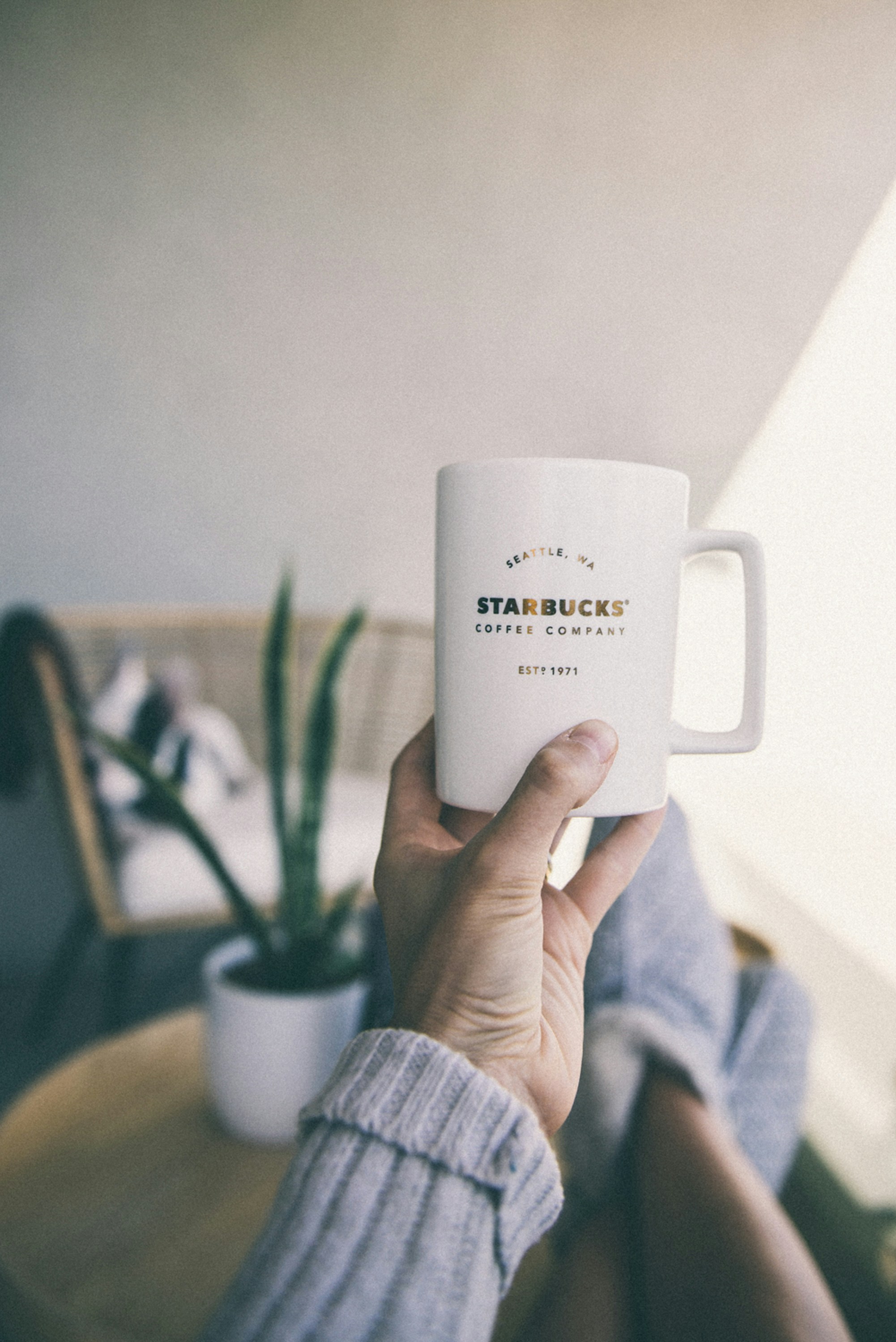 person holding white ceramic mug