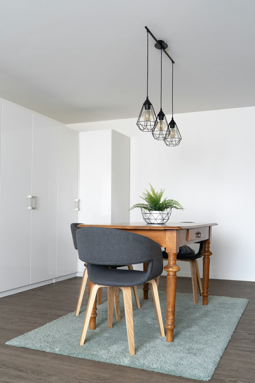 black and white pendant lamp above brown wooden table