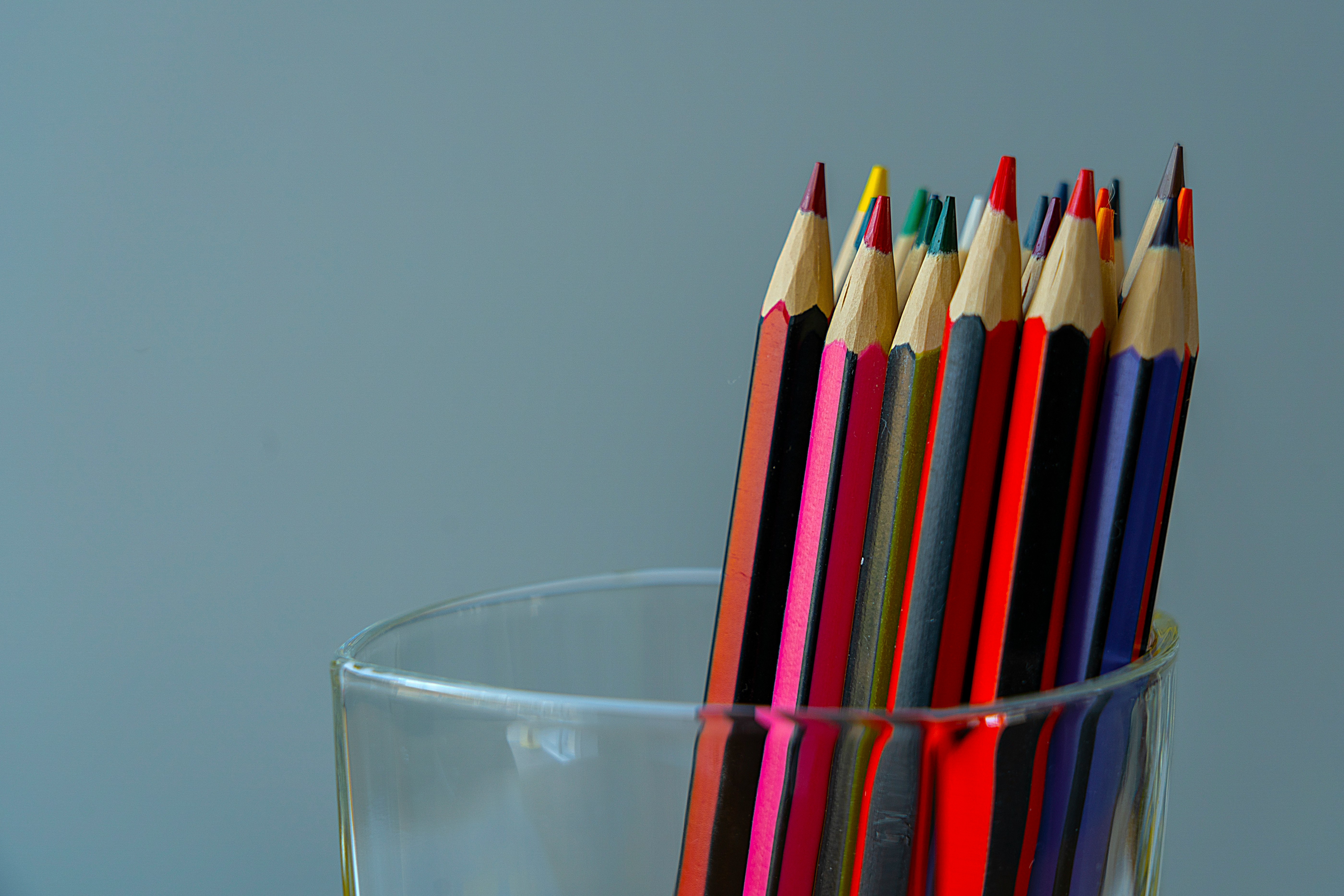 color pencils in clear drinking glass