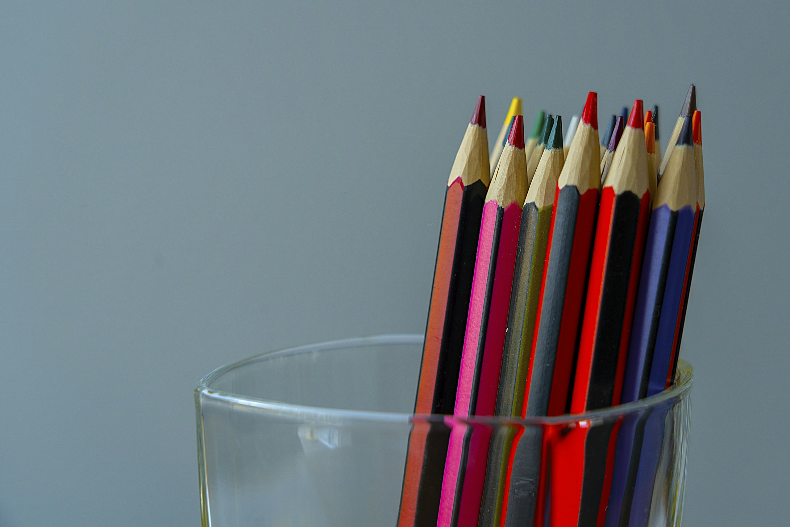 color pencils in clear drinking glass