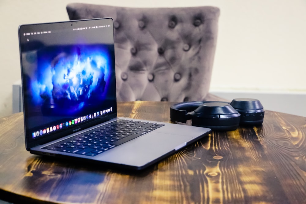 black laptop computer on brown wooden table