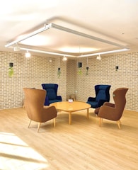 Small seating area with a coffee table and armchairs.