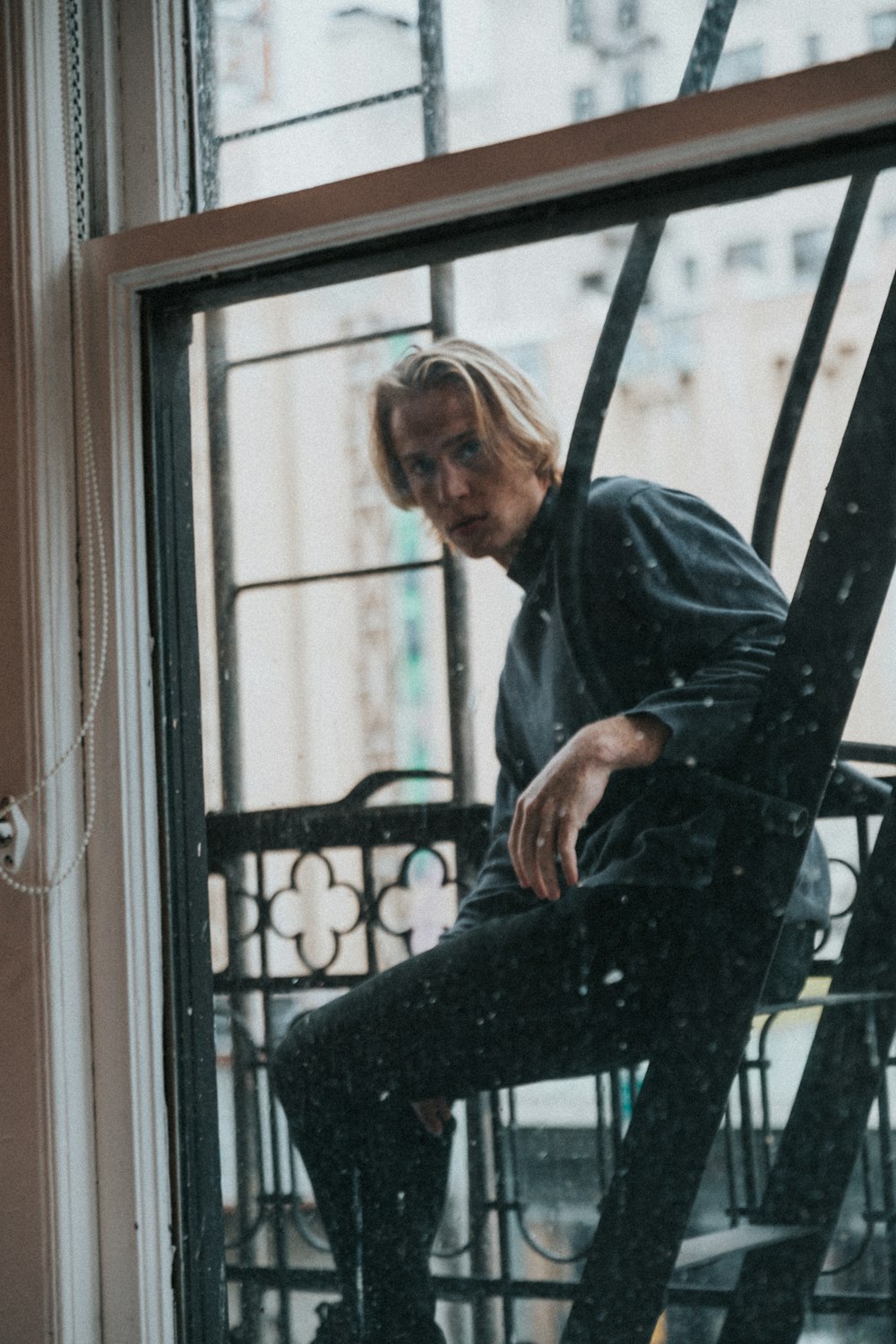 man in black jacket sitting on chair