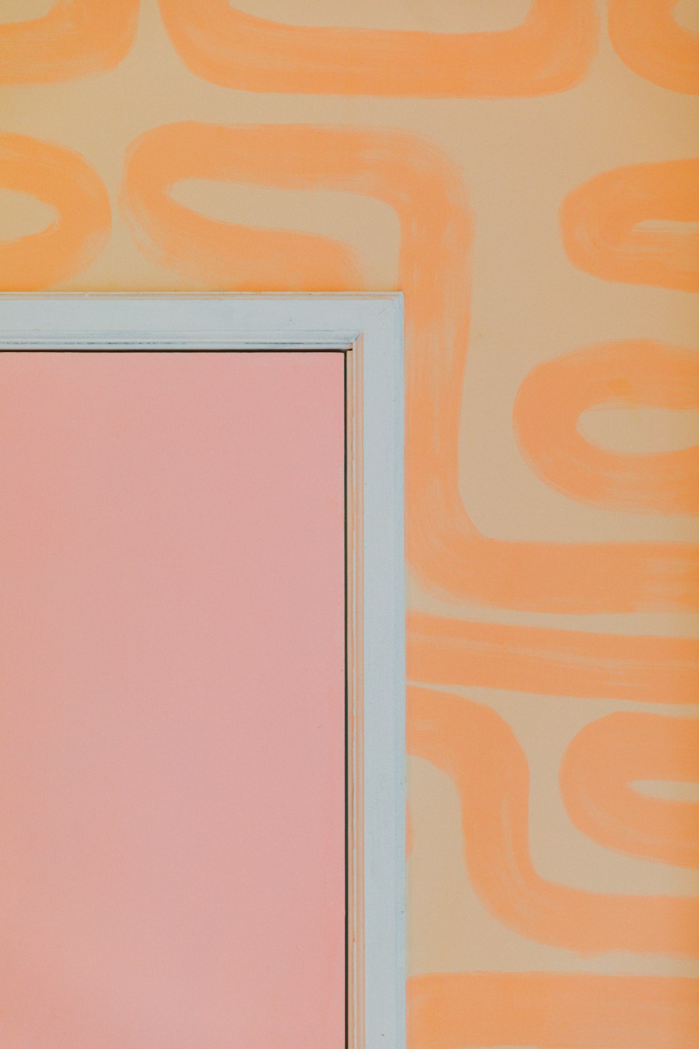 white wooden frame on orange wall