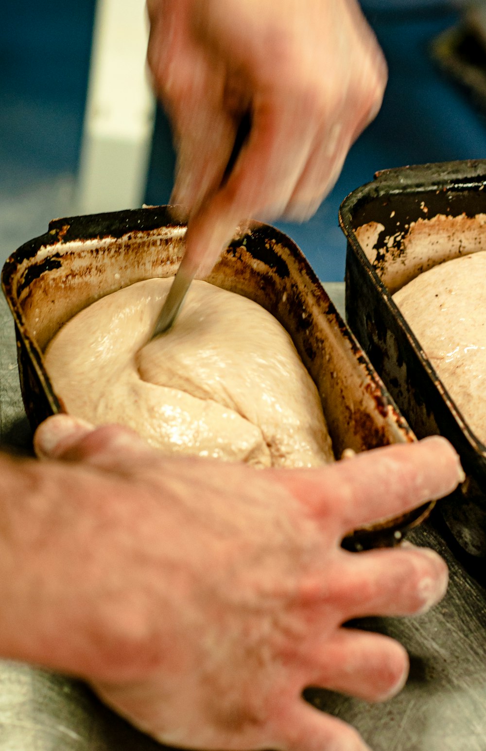 person holding brown bread with white powder