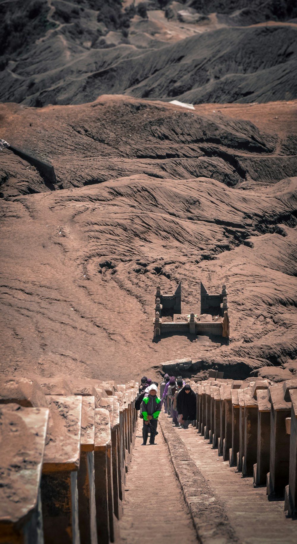 people walking on brown rock formation during daytime