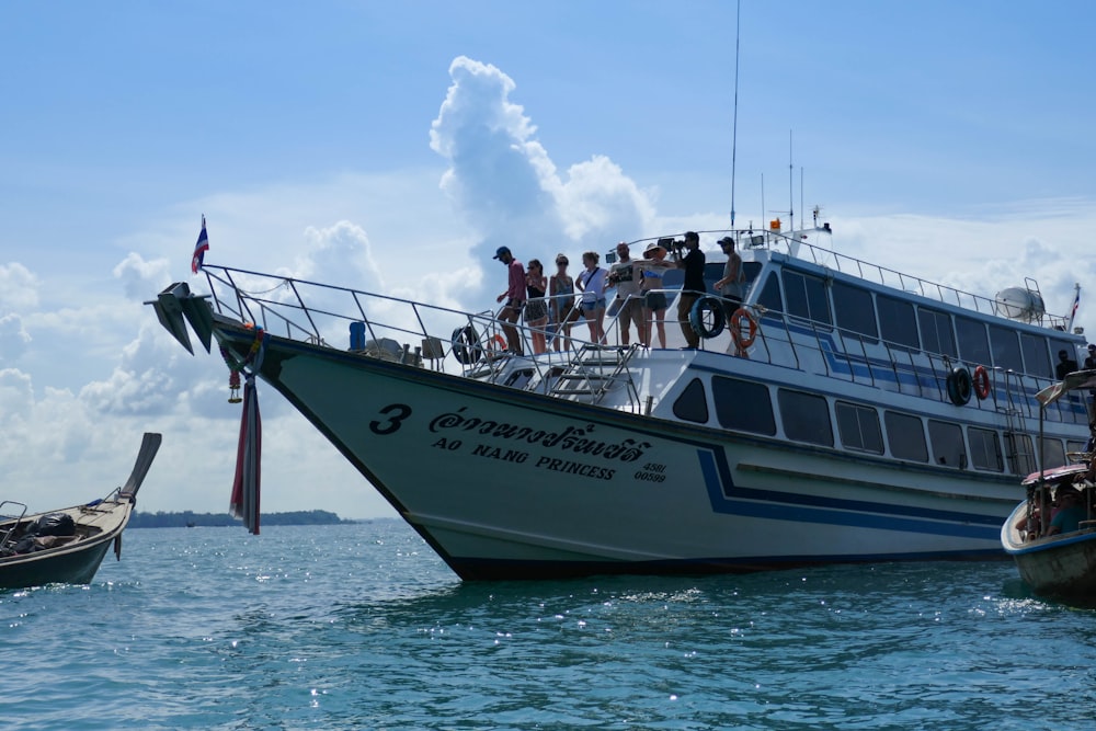 people riding on white and black boat on sea during daytime