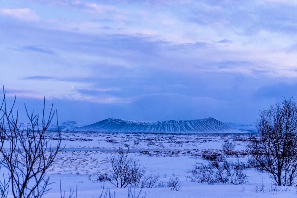 snow covered mountains under cloudy sky during daytime