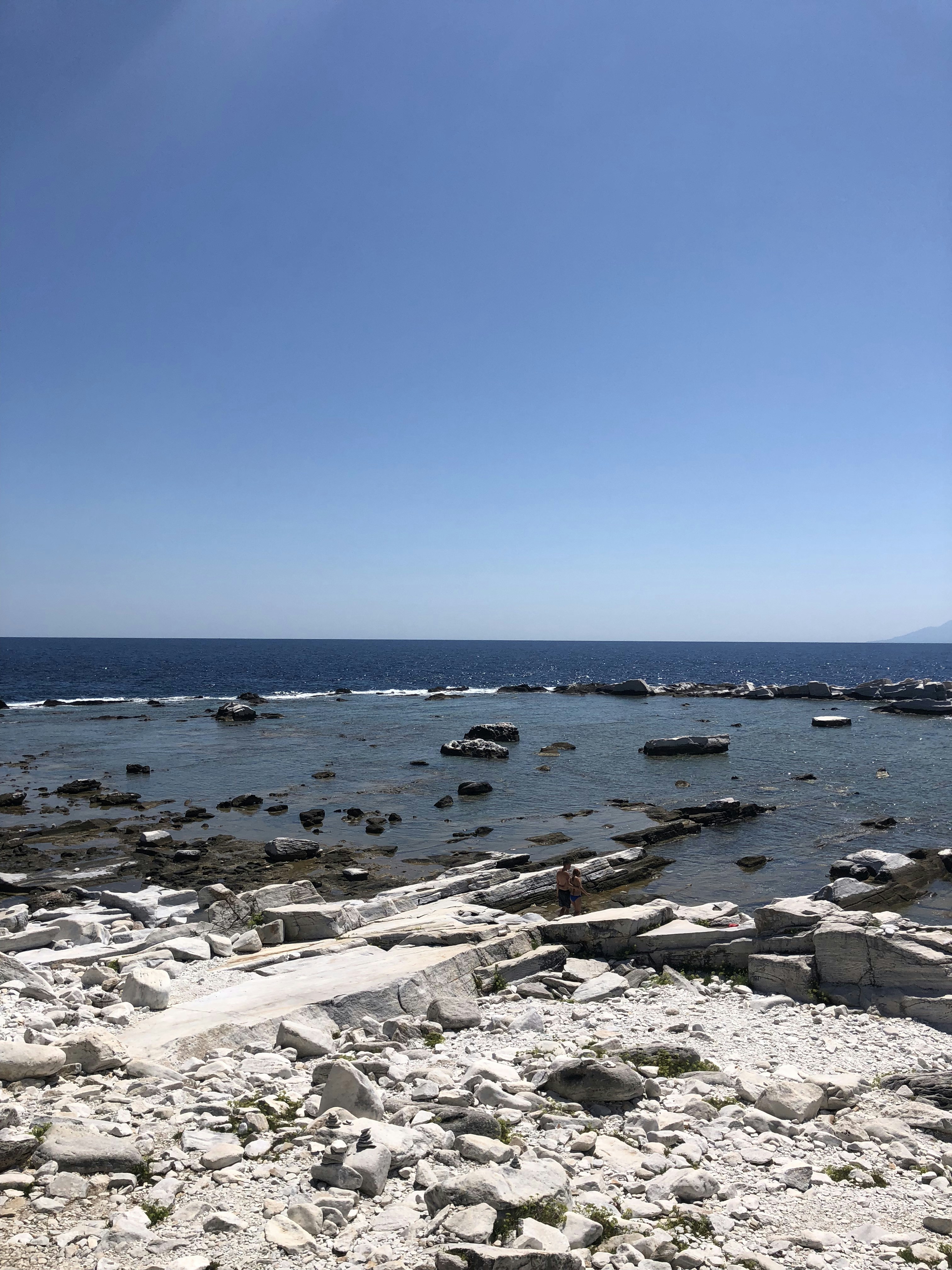 white and black stones on beach shore during daytime