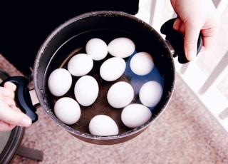 white eggs in black round container