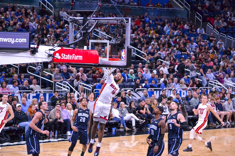 man in white jersey shirt playing basketball