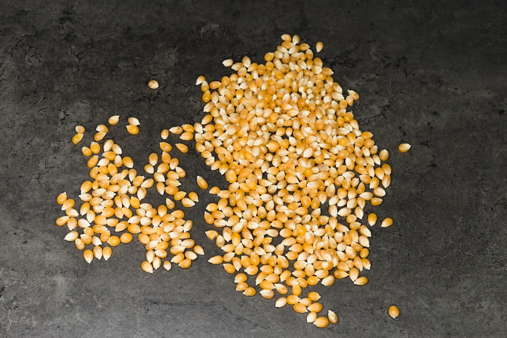 yellow and brown beans on black surface