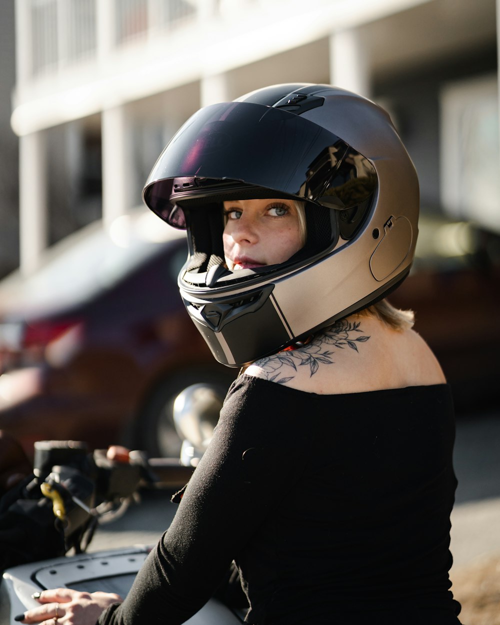 woman in black and white motorcycle helmet and black tank top