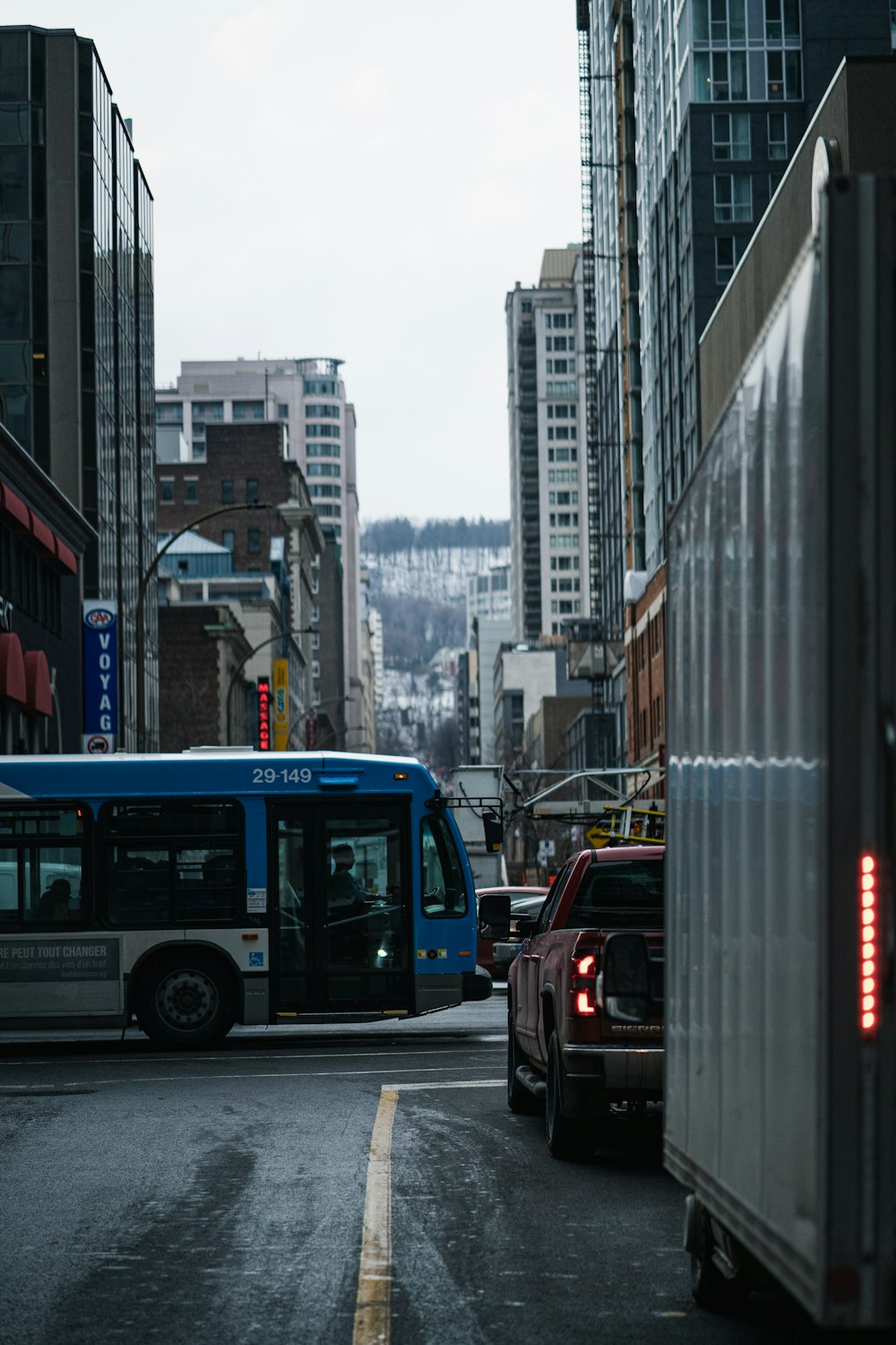 blue bus on road near high rise buildings during daytime