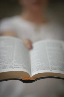 A middle-aged man highlighting text in a book, showing concentration and determination to improve reading speed.